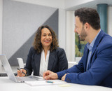 Two students in the Bachelor of Business Administration program talking.