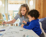 A CapU Early Childhood Care & Education student in the Fulmer Centre with a child.