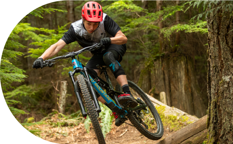 A mountain biker on a blue bike in the forest near Squamish.
