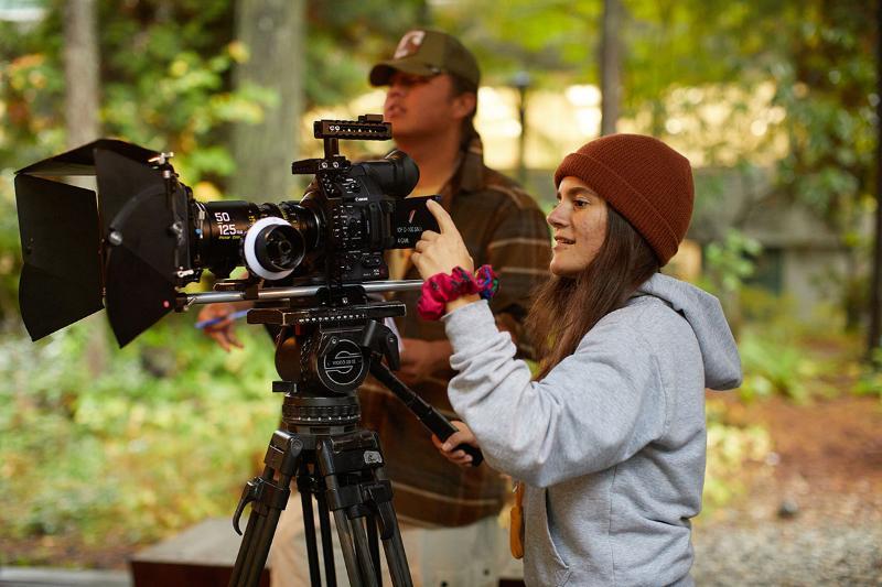 CapU student in the Indigenous Digital Filmmaking program operating a camera. 