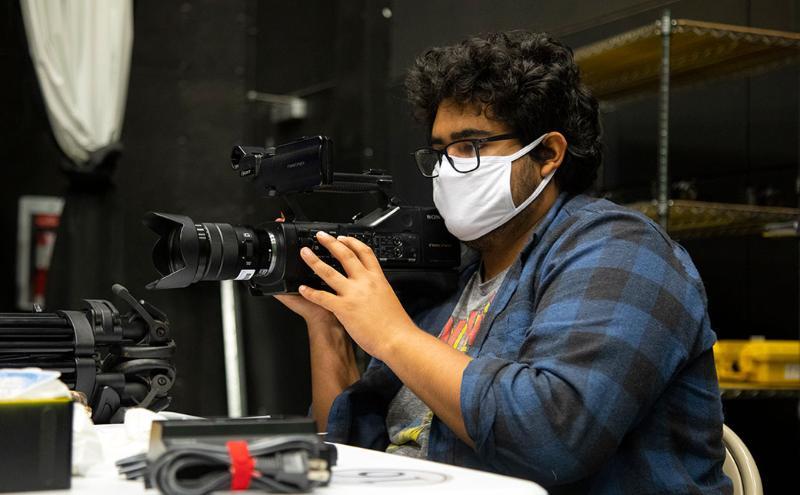 Documentary student with a camera.