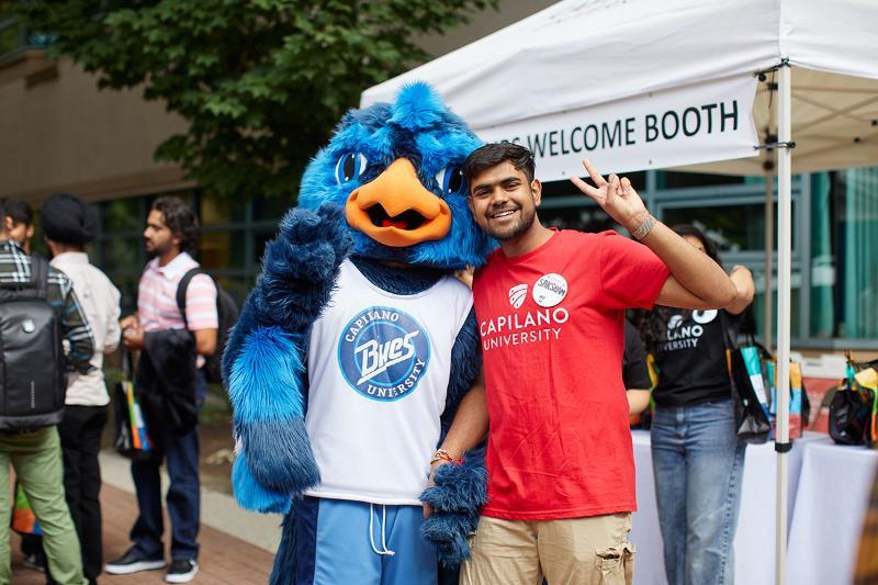 CapU student hanging out with Jay, the CapU Blues mascot.