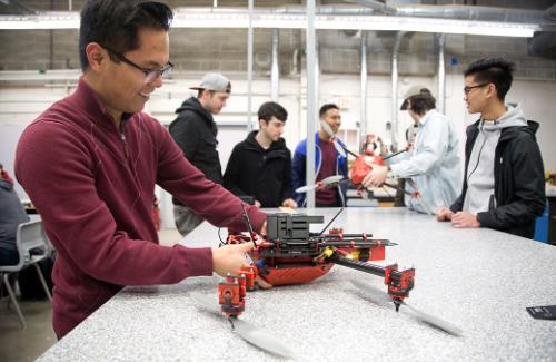 Students building drones in classroom