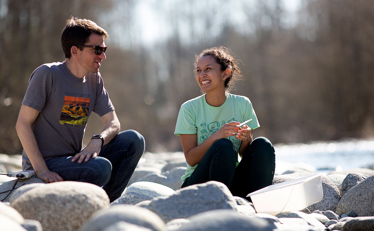 Students sitting at creek for Aquatic Ecology class