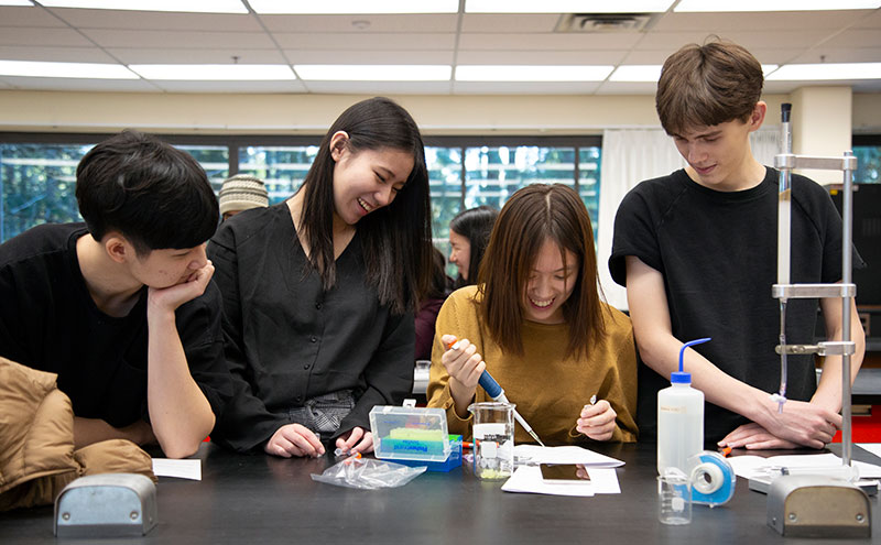 A photo of students working in a science lab together.