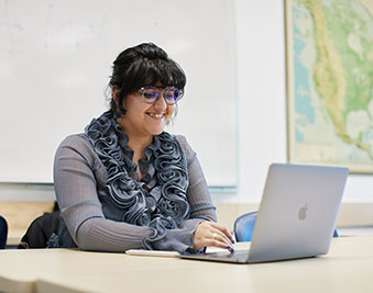 CapU paralegal student working on her computer.