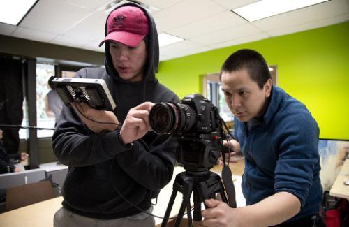 Students with camera filming on campus