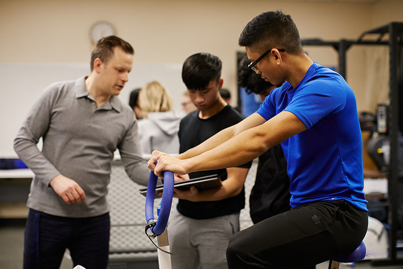 Kinesiology students doing a test on an exercise bike.