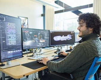 CapU student at a VFX terminal.