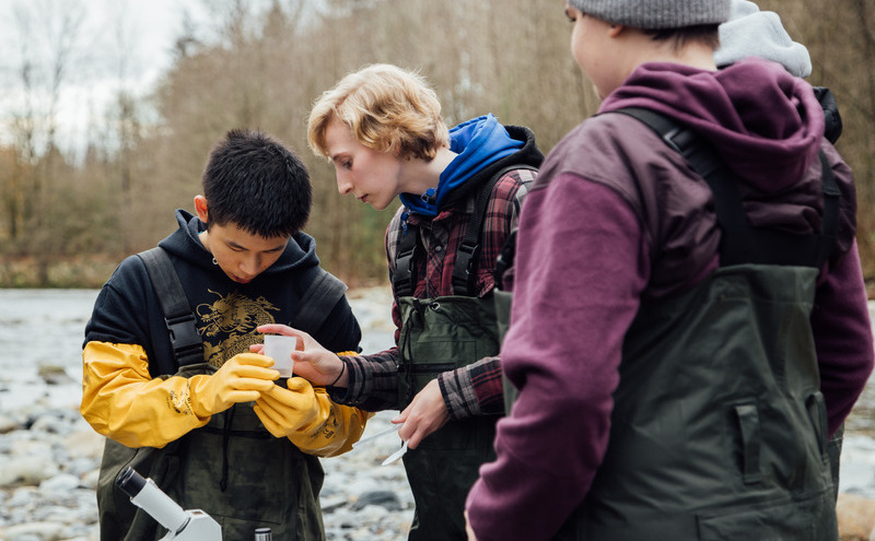 Three environmental sciences students at Lynn Creek.