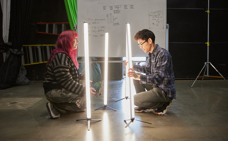 CapU lighting students setting up floor lights.