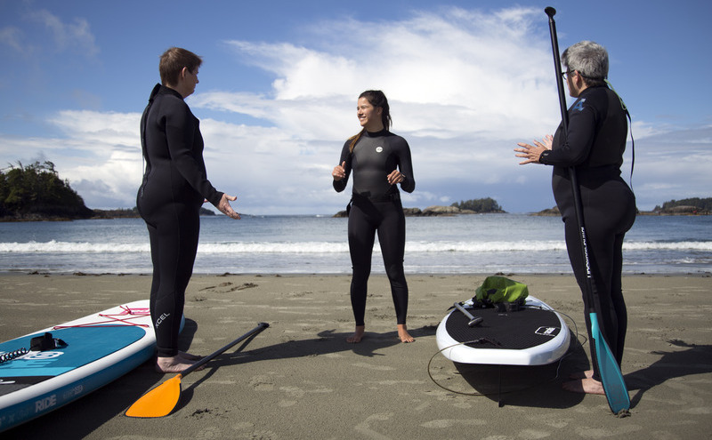 Student in surfing gear at beach