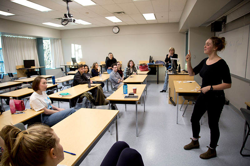 Students listening in a public speaking seminar.