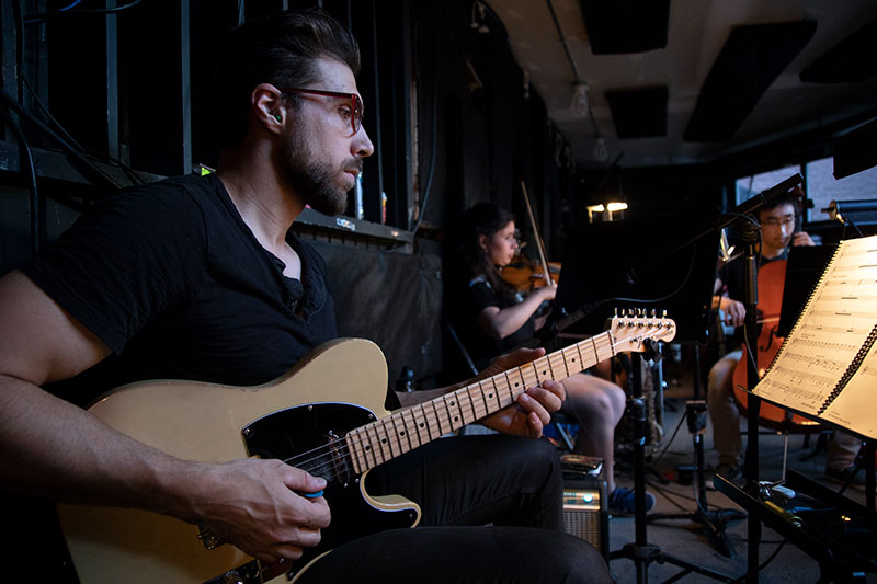 Guitarist playing as part of a Music Diploma concert.