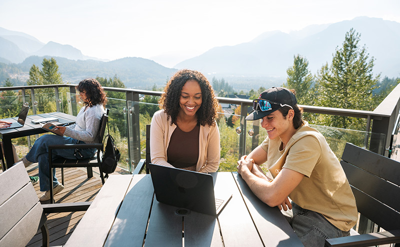 Two students studying at a table at CapU Squamish Campus.