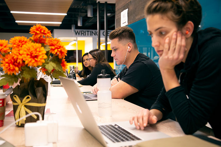 Students in the Learning Commons studying on their laptops.