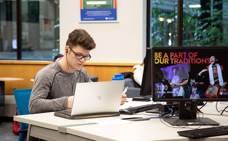 Student at desk in front of laptop