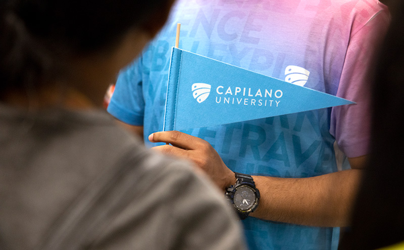 Student holding Capilano University flag