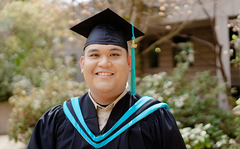 Student in cap and gown at graduation ceremony