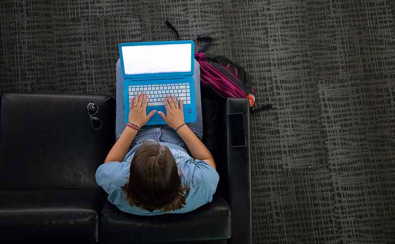 Student working on laptop in the library