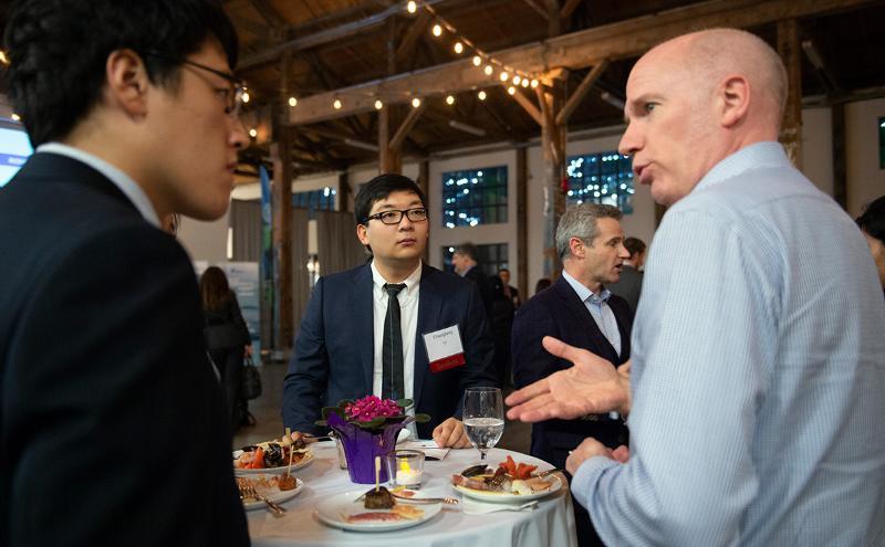 Students attending a networking event talking to a participant