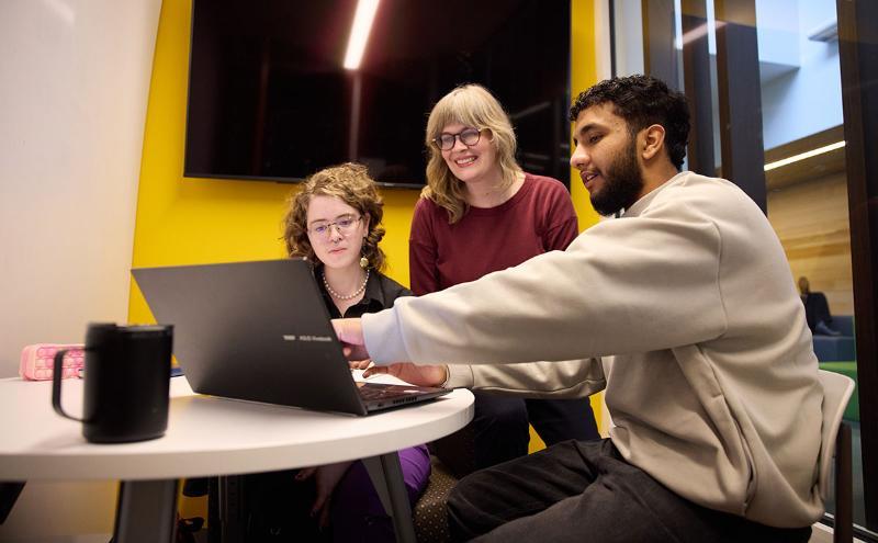 Faculty member helping two students