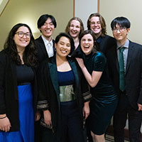 musica intima standing for a photo and smiling