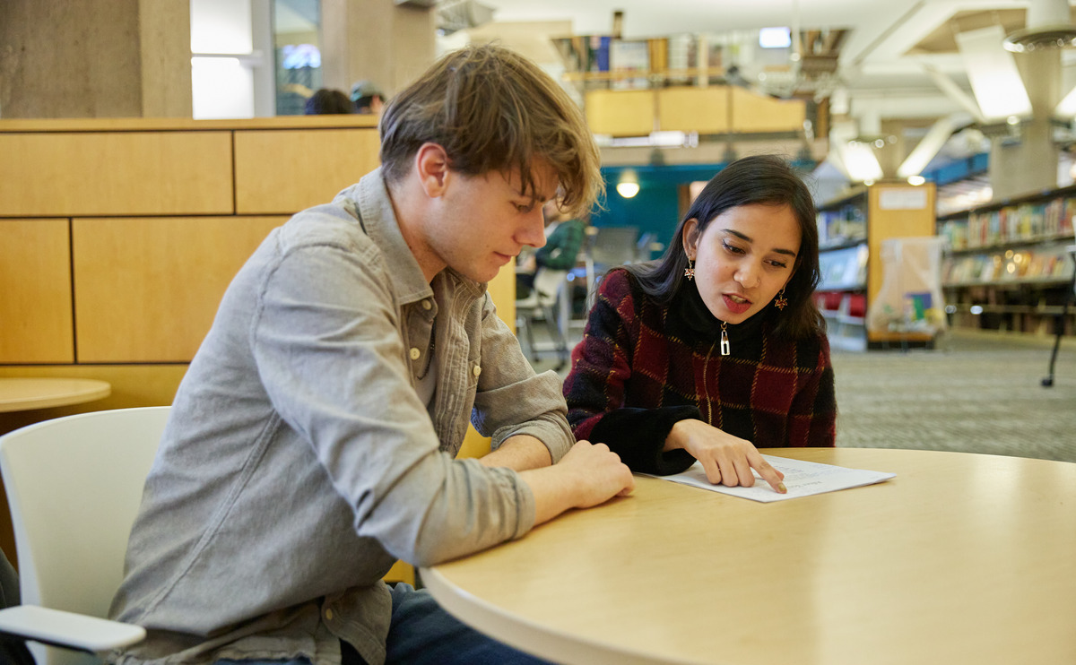 Two CapU students studying together.