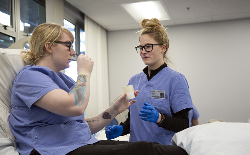 A student is being seen by a medical professional on campus