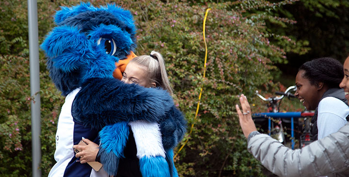 Students outside with CapU mascot