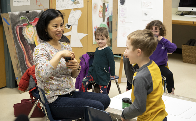 Children interacting with a teacher