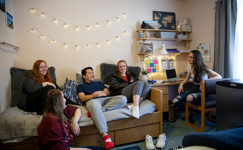 Students talking in room at CapU Residence