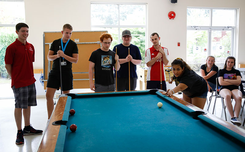 Students playing pool in CapU Residence