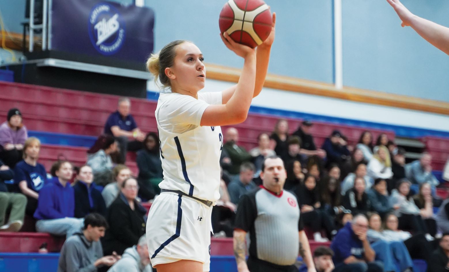 Photo of female athlete Maddy Coffin playing basketball